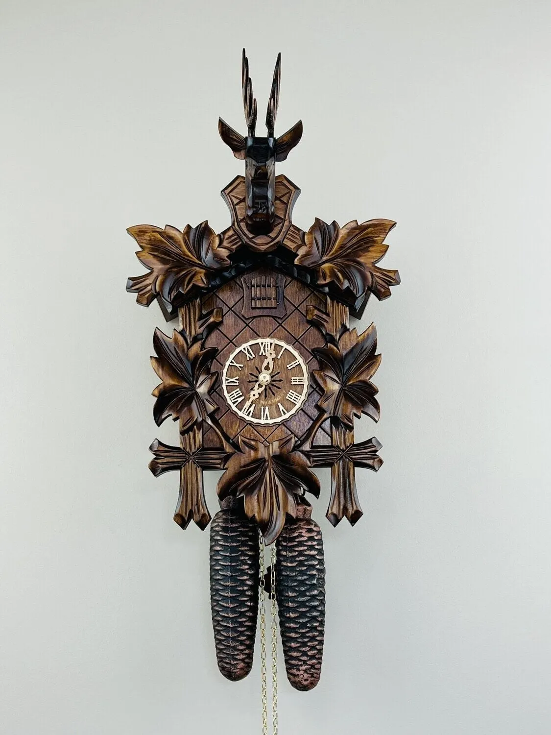 Eight Day Hunter's Cuckoo Clock with Hand-carved Maple Leaves, Rifles, and Buck